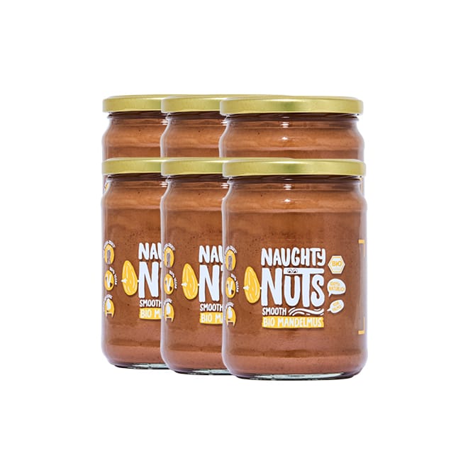 Sechs Gläser Bio Mandelmus Smooth 500g mit goldenen Deckeln und Naughty Nuts Etiketten