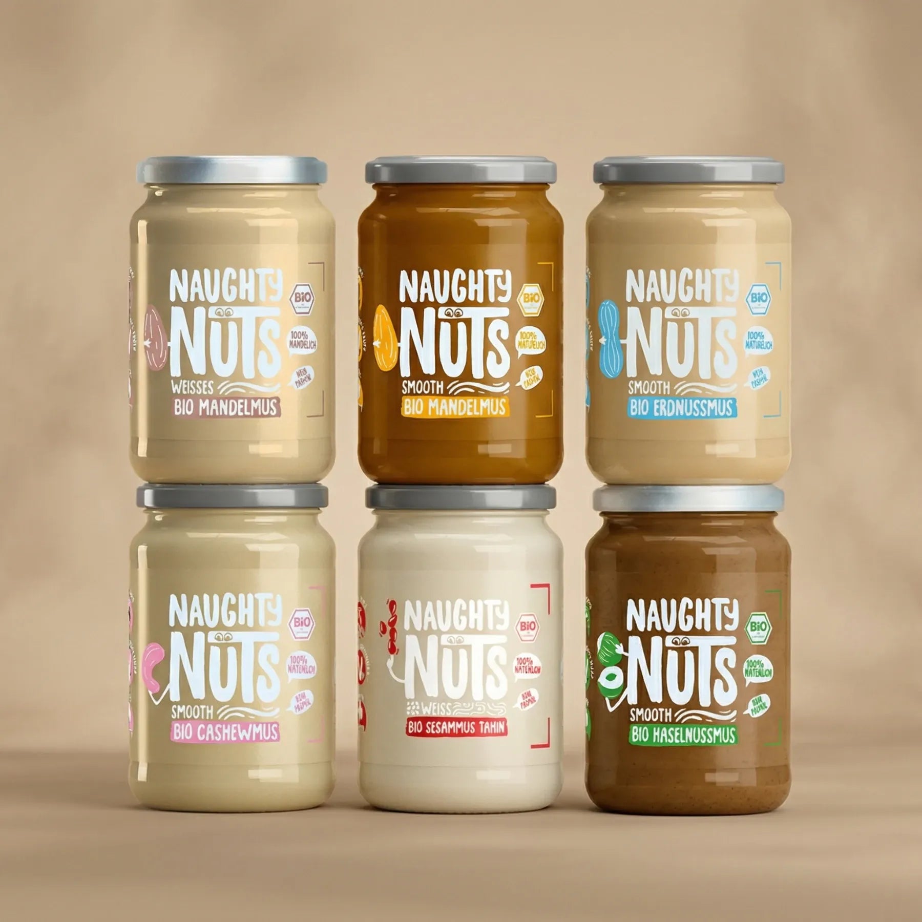Sechs Gläser Naughty Nuts Nussmus, darunter Mandelmus, Erdnussmus, Cashewmus, Sesammus und Haselnussmus